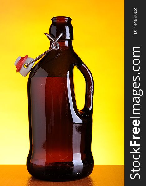 Old beer bottle on yellow background