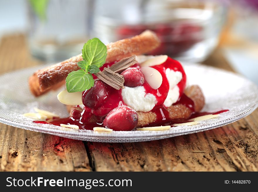 Fan-shaped puff pastries with cream, cranberries and syrup. Fan-shaped puff pastries with cream, cranberries and syrup