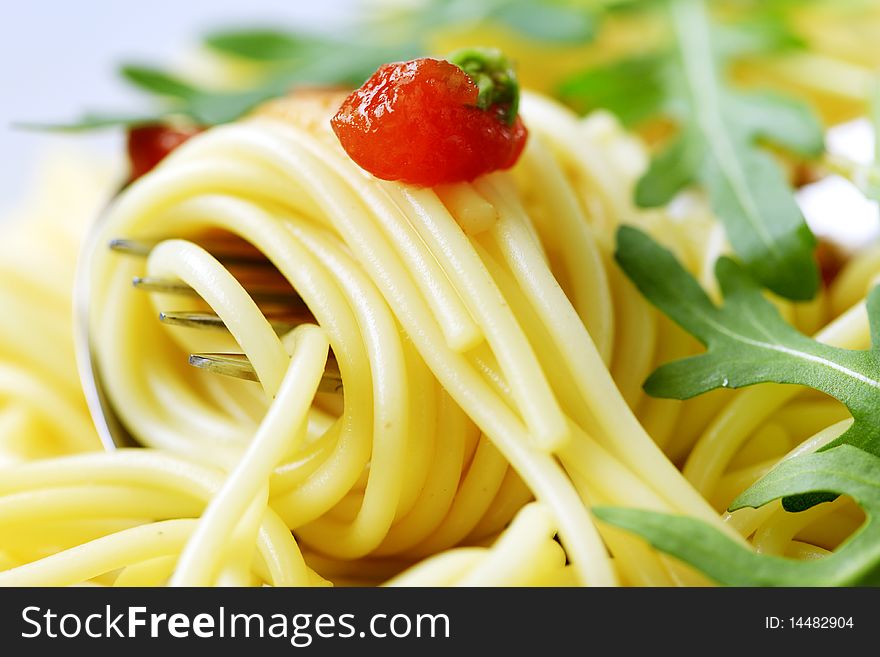 Macro shot of spaghetti twirled around a fork