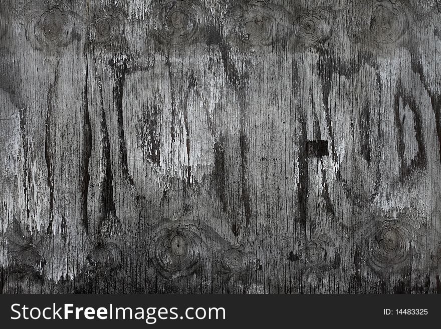 A faded plywood board showing knots and wood grain. A faded plywood board showing knots and wood grain