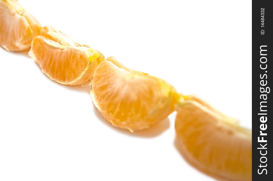 Row of mandarin segments isolated over white