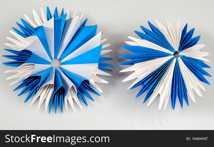 White and blue origami virus or snowflake or flower. White and blue origami virus or snowflake or flower