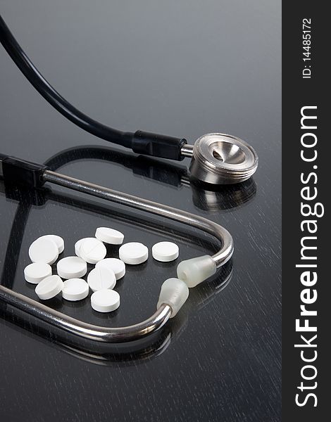 Stethoscope with tablets on a table