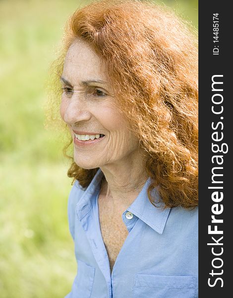 Profile of a Pretty Senior Woman With Bright Red Hair