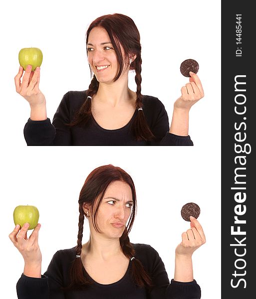 Beautiful woman choosing between chocolate cookies and apple on white background