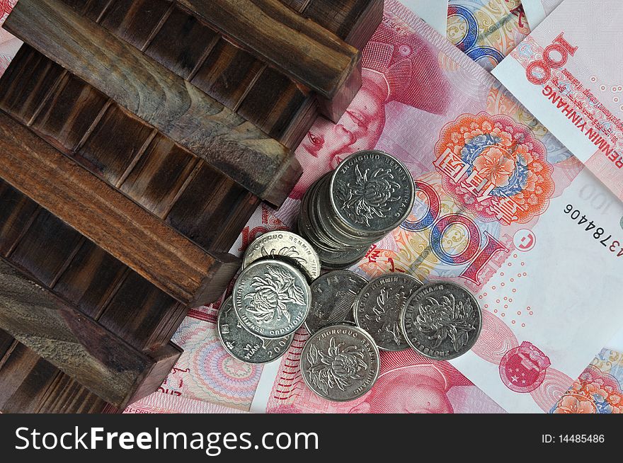 Old wooden box with coin beside, putting on money notes, means money keeping, saving, money protection collection. Old wooden box with coin beside, putting on money notes, means money keeping, saving, money protection collection.