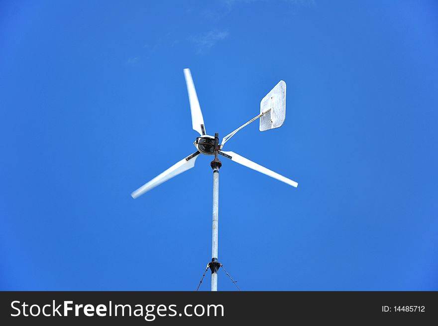 Running wind wheel against blue sky.