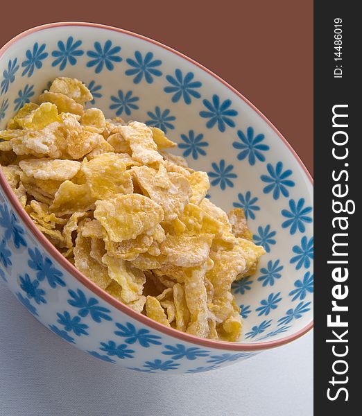 A bowl of corn flakes cereal. A bowl of corn flakes cereal