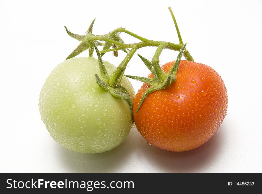 The two fresh tomato on the white background