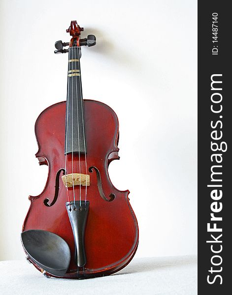Old and preserved violin shot in white background. Old and preserved violin shot in white background