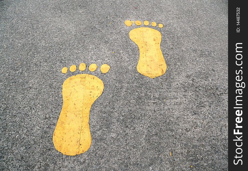 Two painted footprints on the asphalt. Two painted footprints on the asphalt