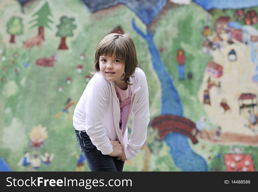 Happy young girl posing and jumping with abstract urban style painting bacground begind. Happy young girl posing and jumping with abstract urban style painting bacground begind