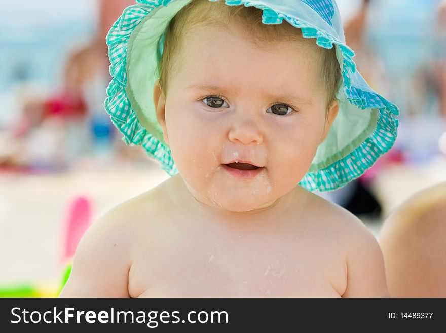 Happy baby with food all over the face.