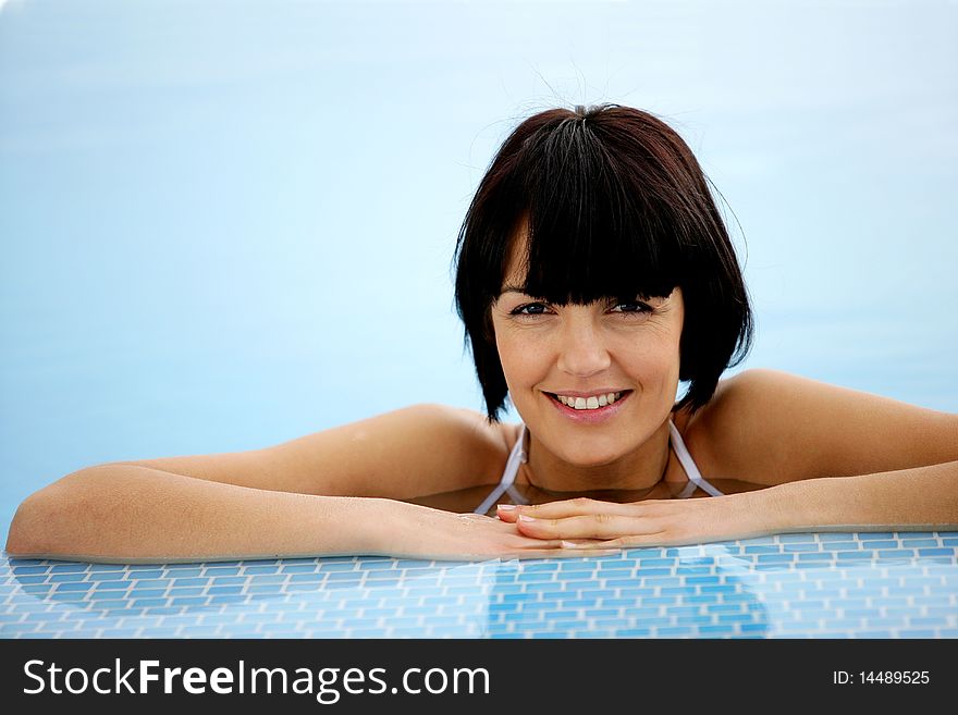 Closeup of beautiful young woman in a swimming pool. Closeup of beautiful young woman in a swimming pool