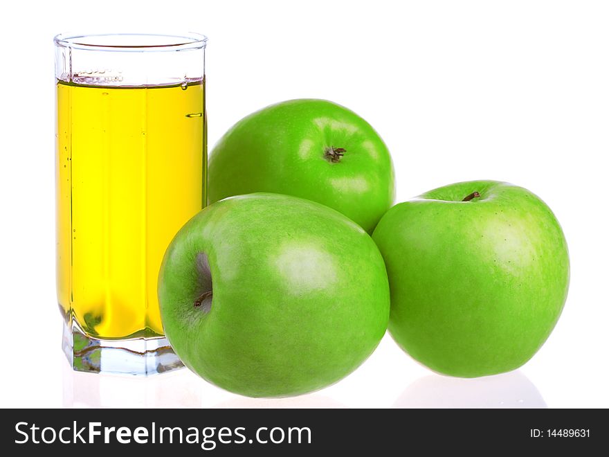 Glass of apple juice with apples isolated on white background