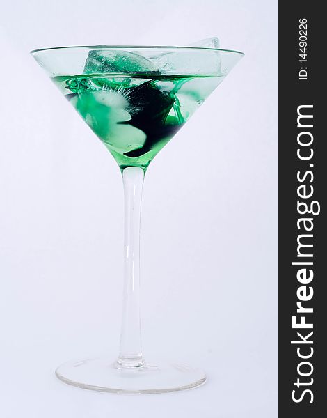 Green cocktail with ice in martini glass