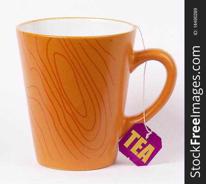 Orange cup of tea over grey gradient background (macro shot)