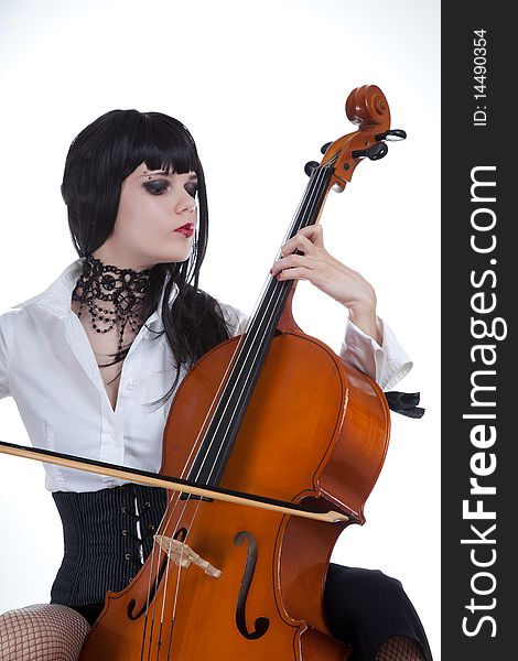 Attractive girl playing cello, studio shot over white background