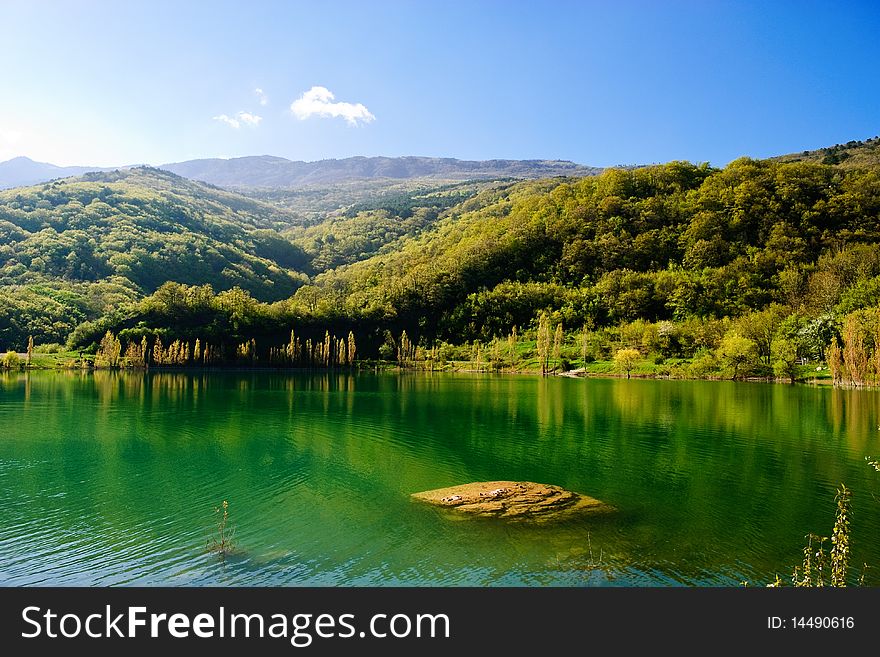 Stone under water in mountain lake. Stone under water in mountain lake