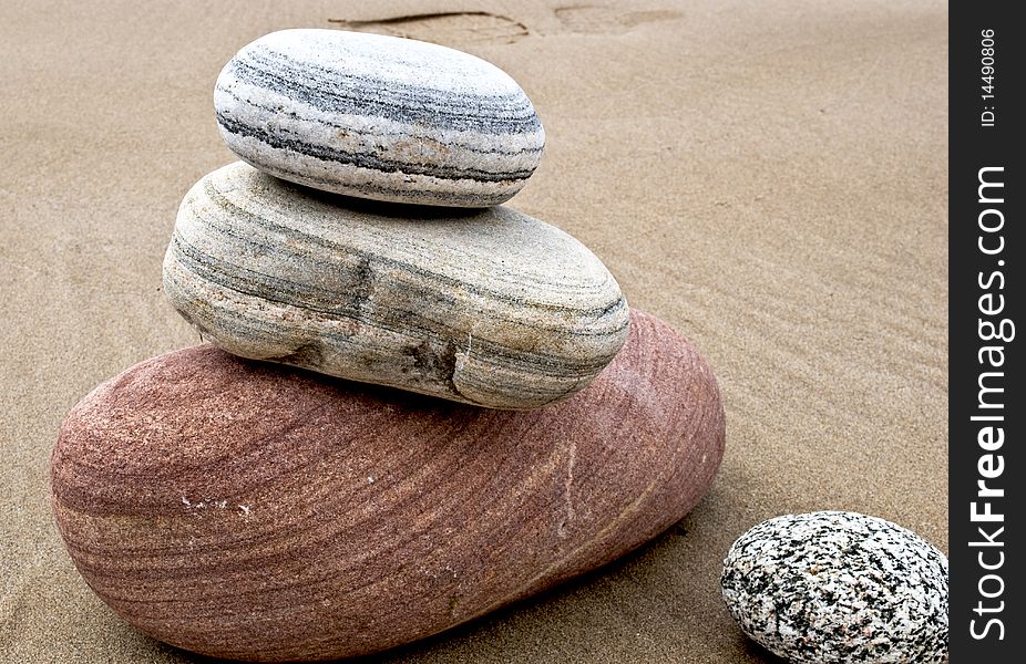 Pile of three balancing stones on the beach. Pile of three balancing stones on the beach