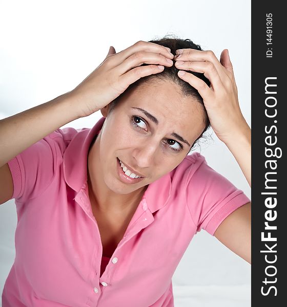 Concerned woman, checking her hair. Concerned woman, checking her hair