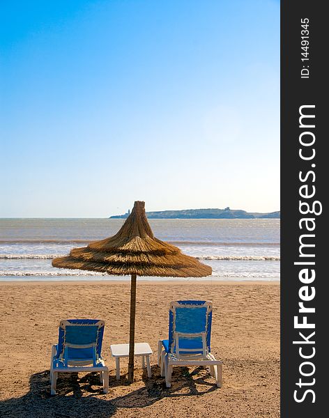 Perfect sunny day with a straw Parasol on the beach. Perfect sunny day with a straw Parasol on the beach.