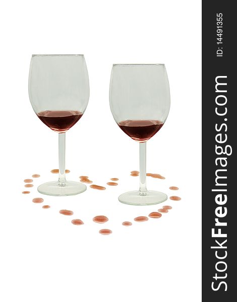 Glasses with wine and splashes in the form of heart on a white background