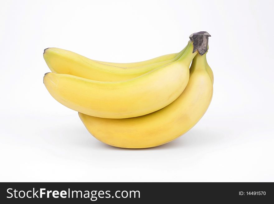 Five ripe bananas on a white background