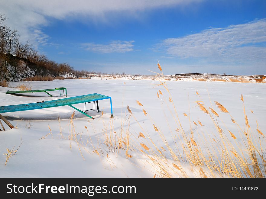 Pier near the frozen lake. Winter. Pier near the frozen lake. Winter