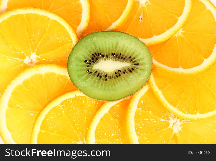 Kiwi and orange slices, juicy fruit background