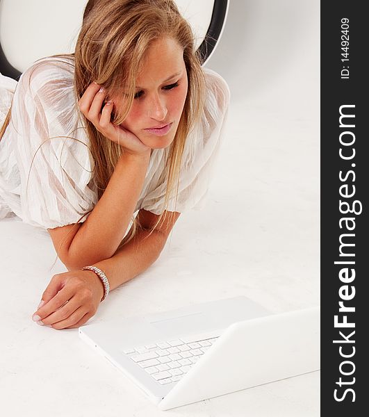 Young woman using laptop computer. Isolated against white background.