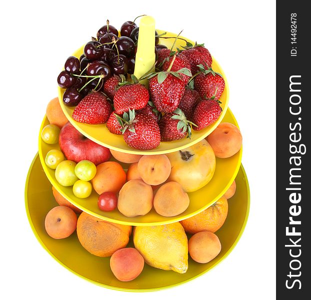 Fruits in green vase insulated on white background, sweet cherries strawberries apple oranges discharges apricots lemon. Fruits in green vase insulated on white background, sweet cherries strawberries apple oranges discharges apricots lemon