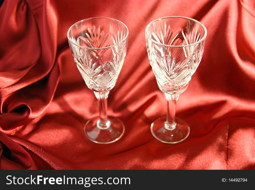 Two goblets on the red cloth background