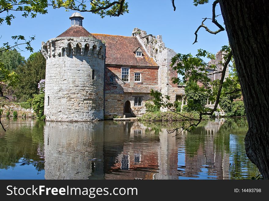 The ruins of an old English castle, set against a vibrant blue sky. The ruins of an old English castle, set against a vibrant blue sky