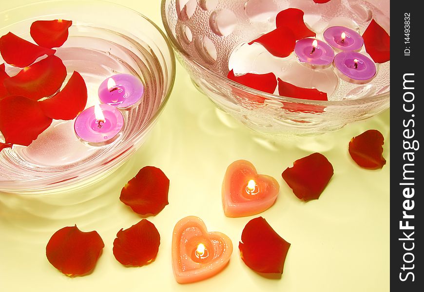 Spa lit candles among damask rose petals. Spa lit candles among damask rose petals