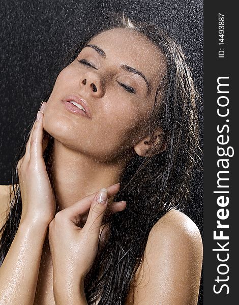 Portrait of the smiling brunette in drop of water on black background. Portrait of the smiling brunette in drop of water on black background