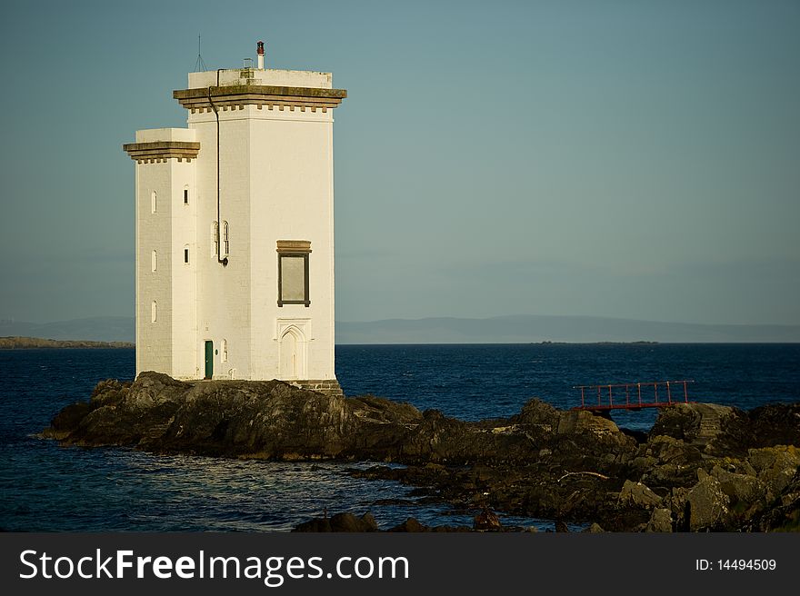 Square lighthouse on the Isle of Sky in Scotland with copy space.