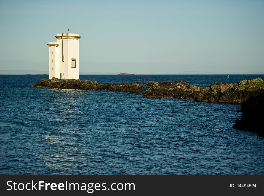 Square lighthouse on the Isle of Sky in Scotland with copy space.