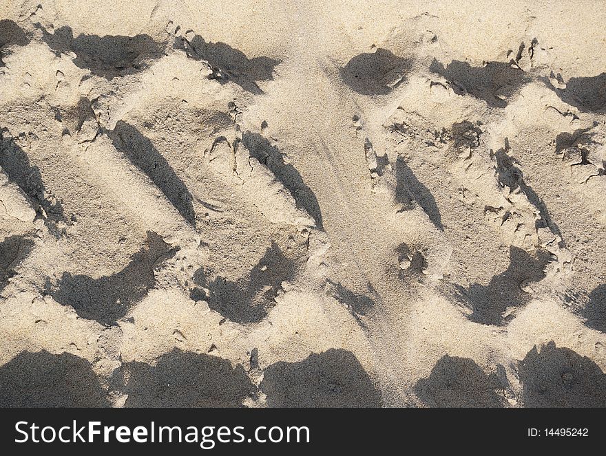 Closeup of tracks made by tires with deep tread in sand. Closeup of tracks made by tires with deep tread in sand.