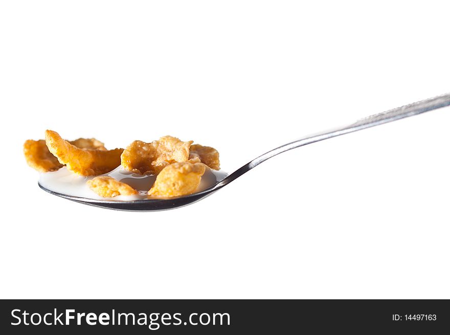 Spoon with corn flakes and milk isolated on white background. Spoon with corn flakes and milk isolated on white background