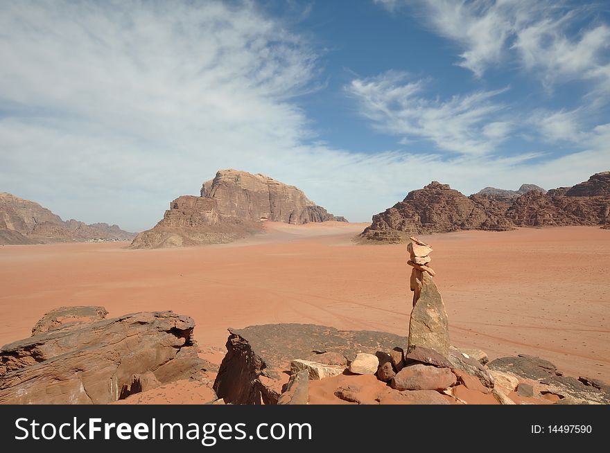 Panoramic view from atop a hill in the UNESCO World Heritage site of Wadi Rum, Jordan, with a rock cairn in the foreground. Panoramic view from atop a hill in the UNESCO World Heritage site of Wadi Rum, Jordan, with a rock cairn in the foreground