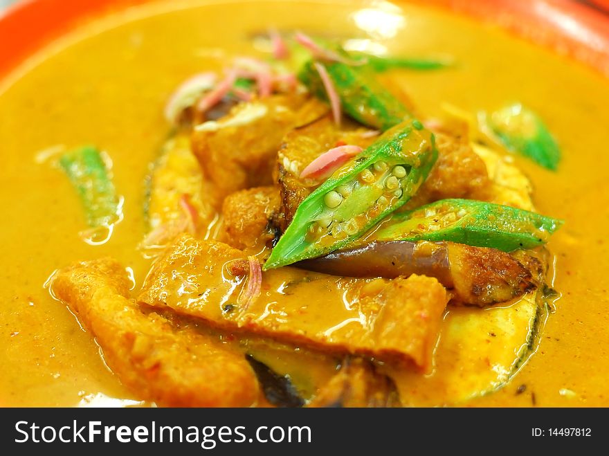 Chinese vegetarian curry cooked with mock fish meat, lady fingers and tomatos. Suitable for food and beverage, healthy lifestyle, and diet and nutrition.