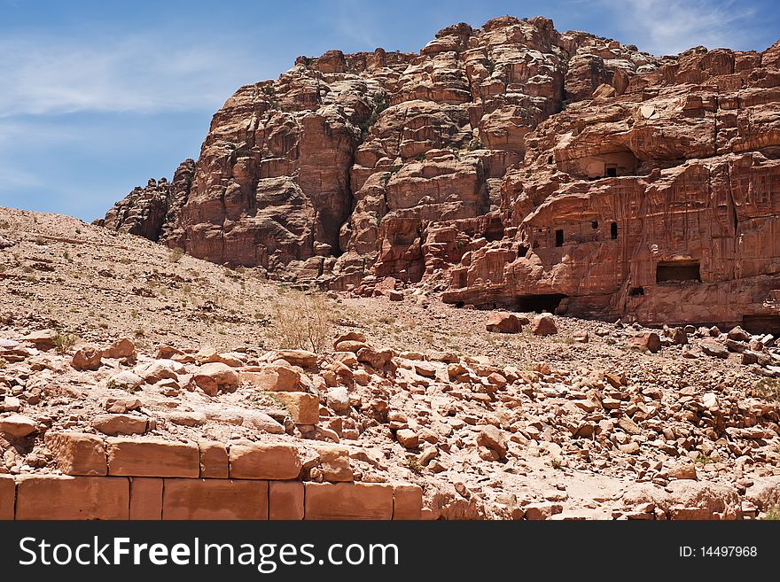 Wide view of large cliff side tomb carved from the beautiful richly-colored sandstone in the ancient city of Petra, Jordan. Wide view of large cliff side tomb carved from the beautiful richly-colored sandstone in the ancient city of Petra, Jordan