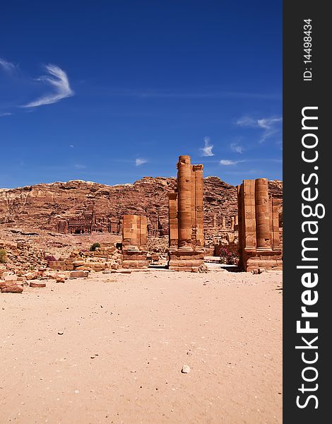 The main avenue of the ancient Nabotean city of Petra, Jordan, with carved tombs on the cliff face in the distance. The main avenue of the ancient Nabotean city of Petra, Jordan, with carved tombs on the cliff face in the distance