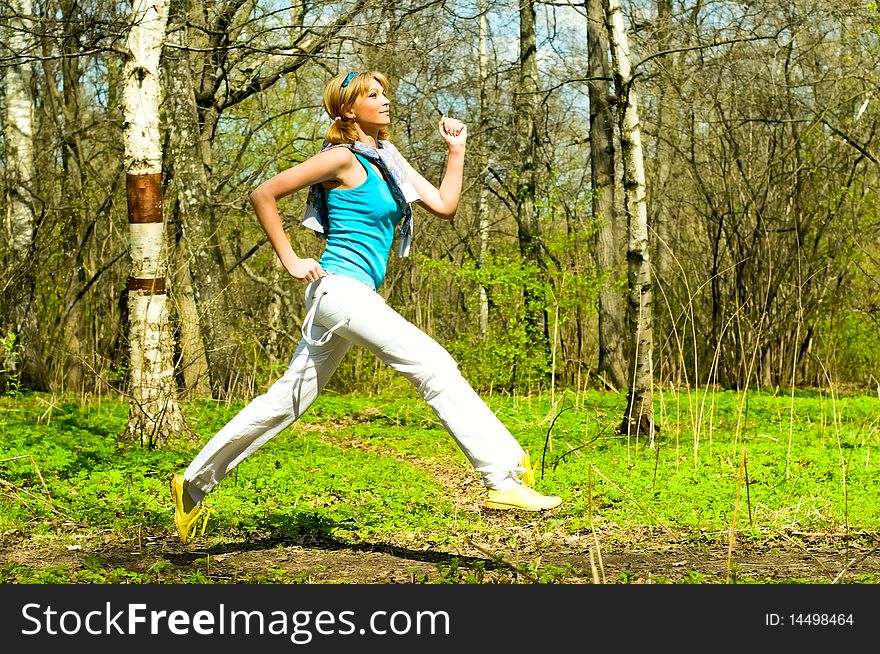 Young woman running on the grass. Young woman running on the grass