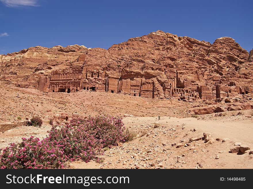 Wide view of large cliff side tomb carved from the beautiful richly-colored sandstone in the ancient city of Petra, Jordan. Wide view of large cliff side tomb carved from the beautiful richly-colored sandstone in the ancient city of Petra, Jordan