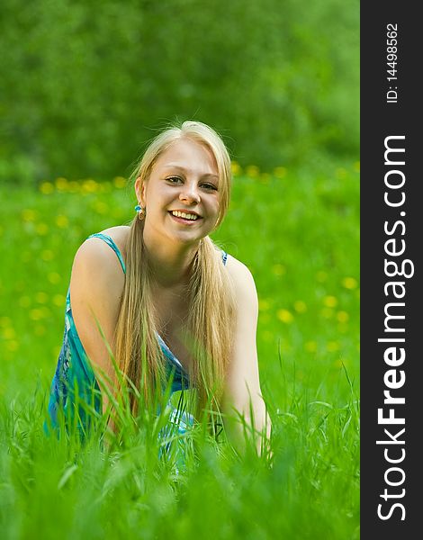 Pretty smiling  girl  relaxing outdoor  in grass