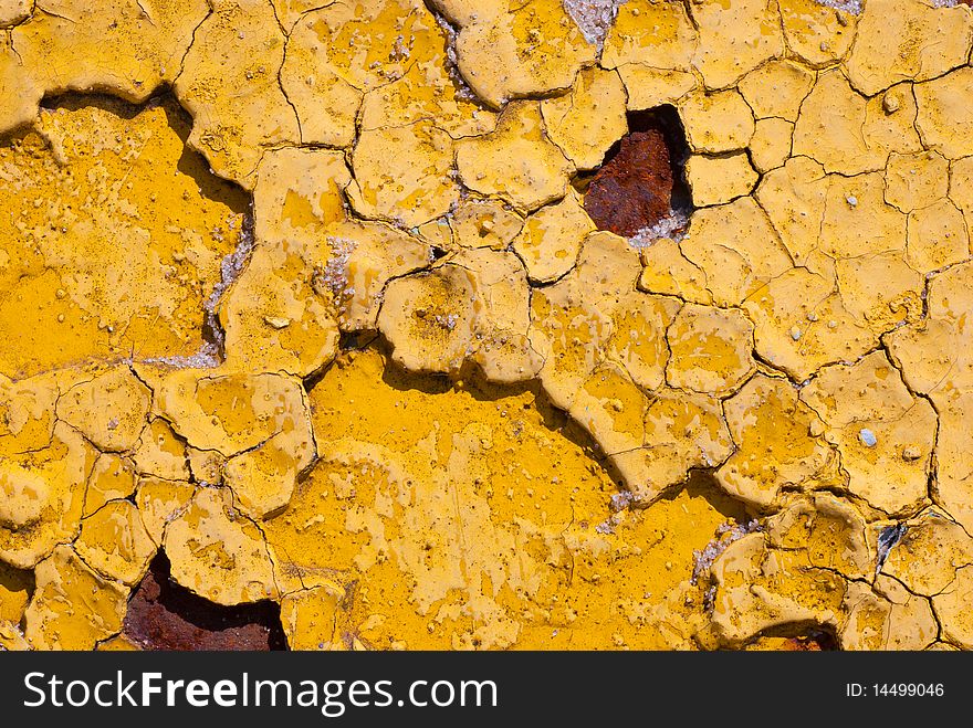 Peeling cracked yellow rusty paint macro background. Peeling cracked yellow rusty paint macro background