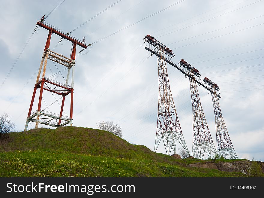 High-voltage equipment over the cloudy sky. High-voltage equipment over the cloudy sky