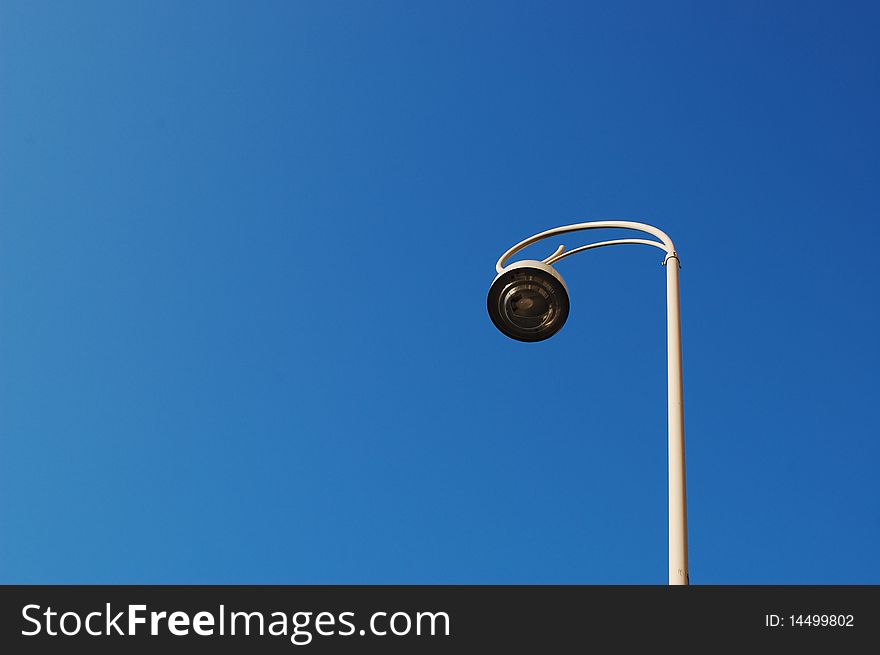 A lamp with a blue sky background